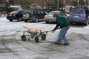 Baited by pepperoni with a little help from Dad, Crockett propels himself across the parking lot.